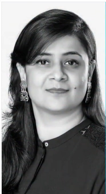 Black and white portrait of a woman with long hair and earrings.